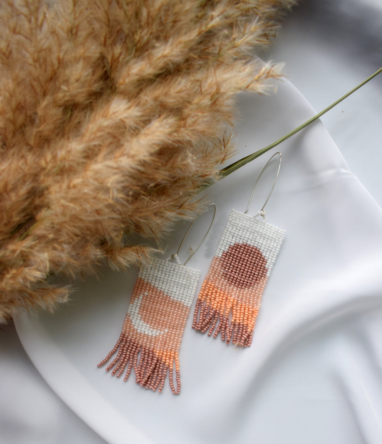 Beige beaded earrings with mountains print