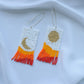 Orange beaded earrings with mountains print