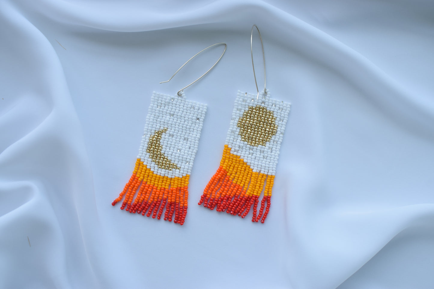 Orange beaded earrings with mountains print