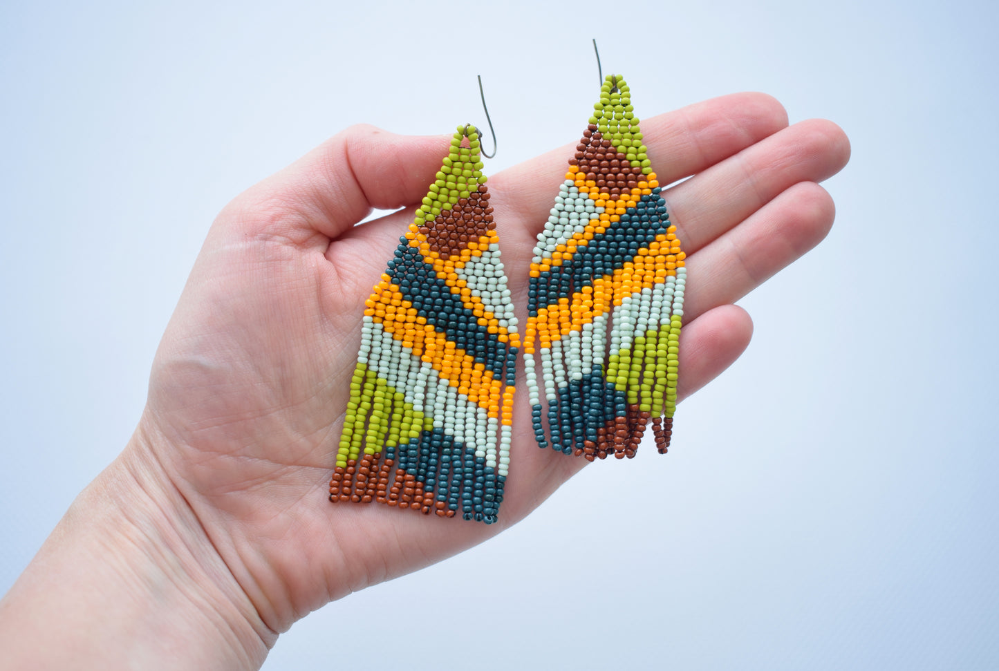 These are beaded earrings with geometric print. These bead earrings are long, colorful and lightweight.  These earrings are made from high-quality Czech beads.