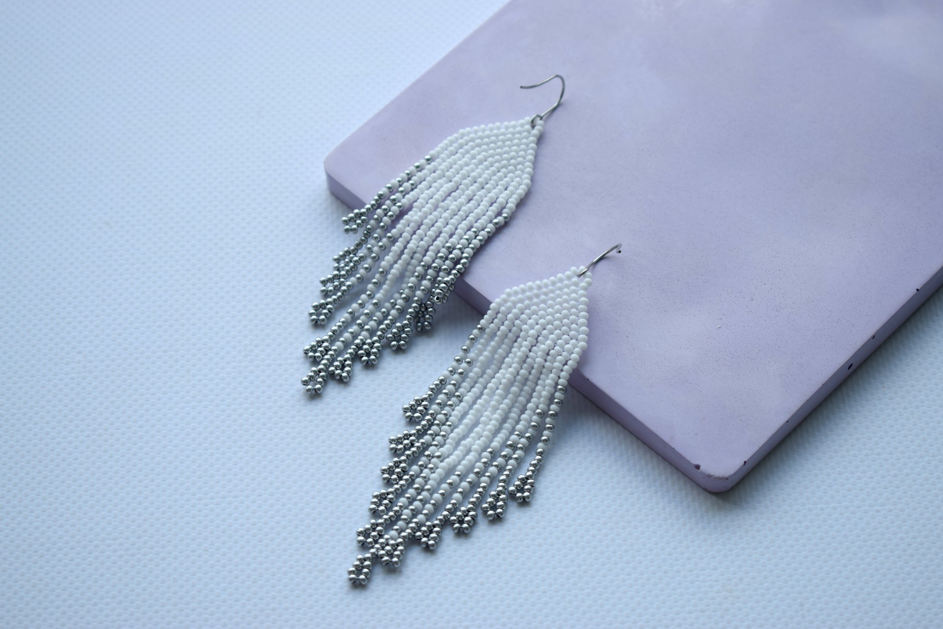 White and silver fringe bead earrings in minimalist style