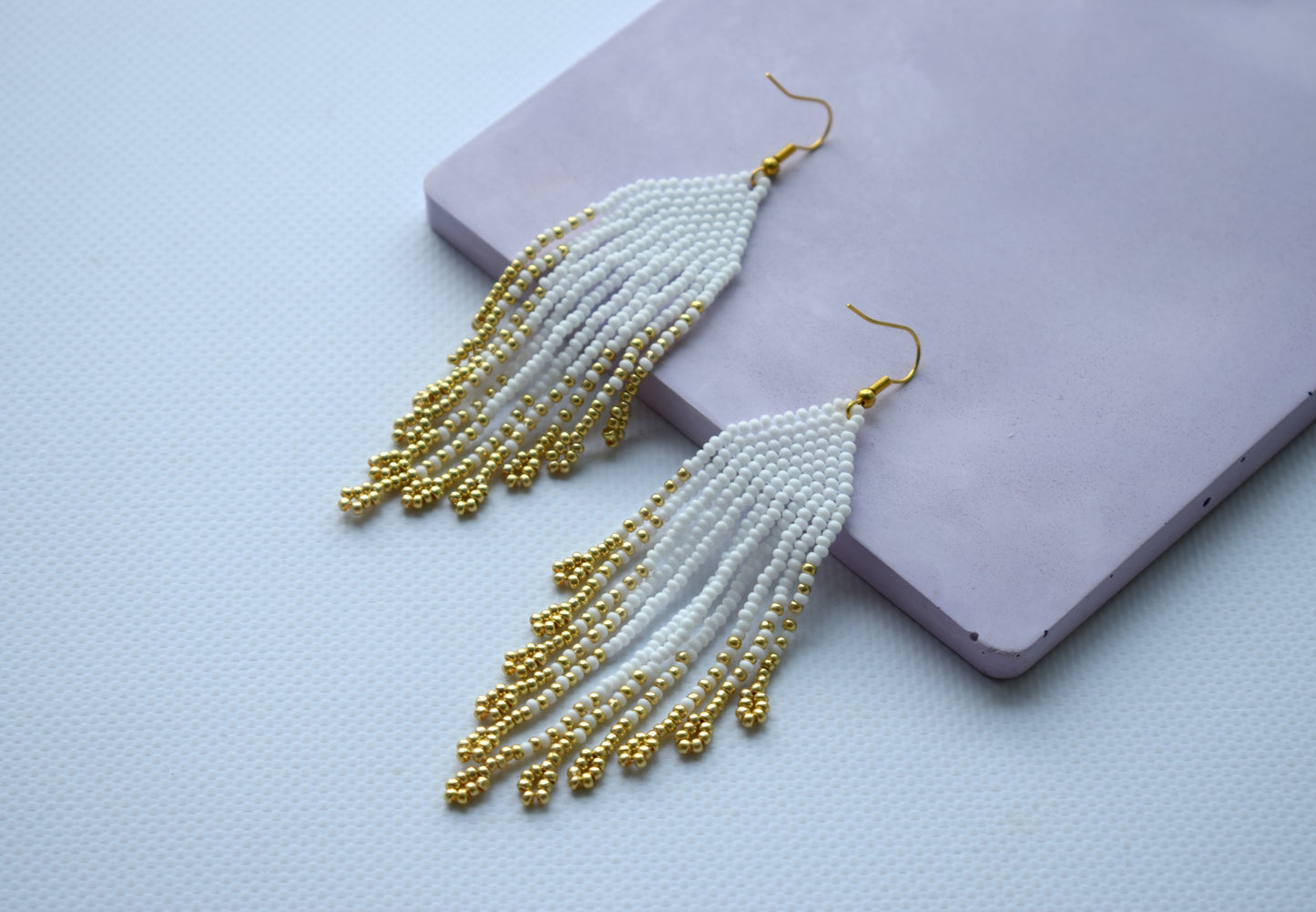 White and gold fringe bead earrings in minimalist style